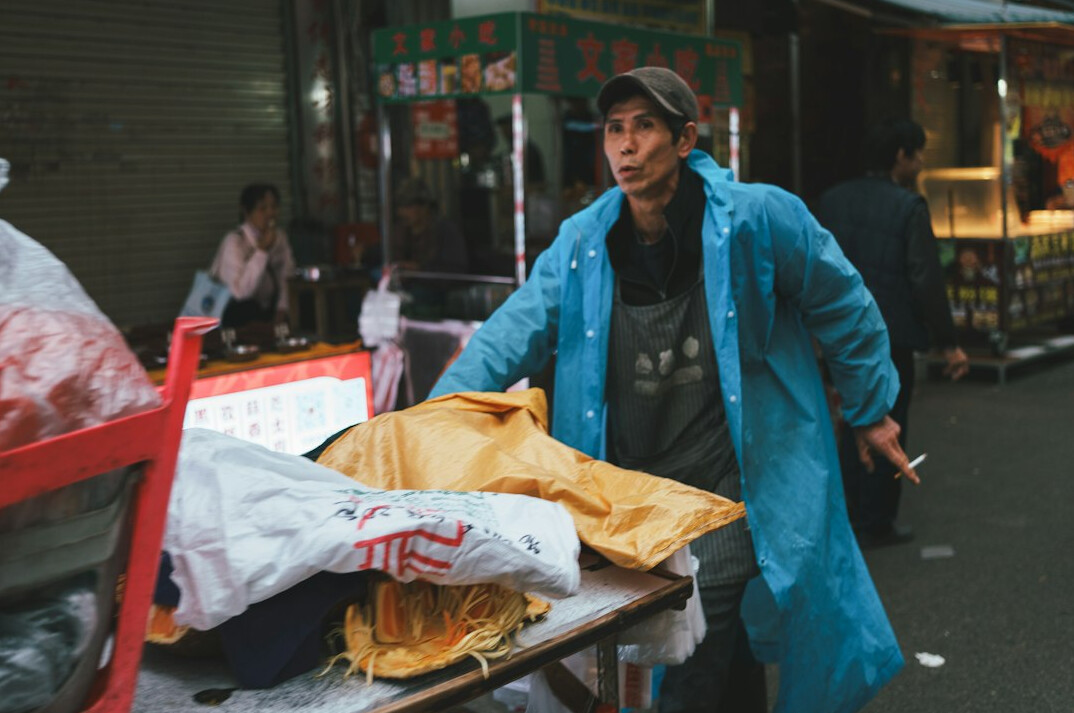woman hiding groceries in coat