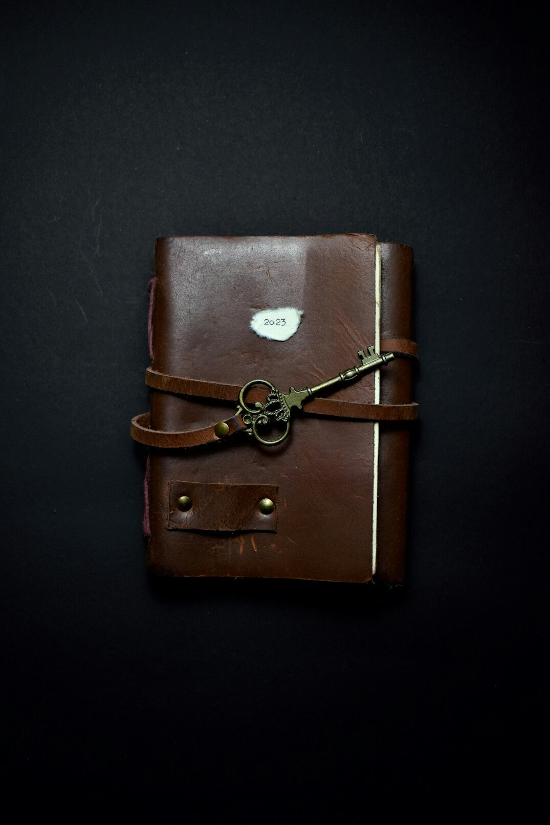Closed vintage diary with an old key and a sepia photograph